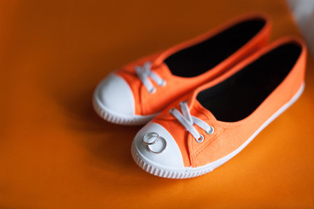 Couple rings on bridal shoesの写真素材