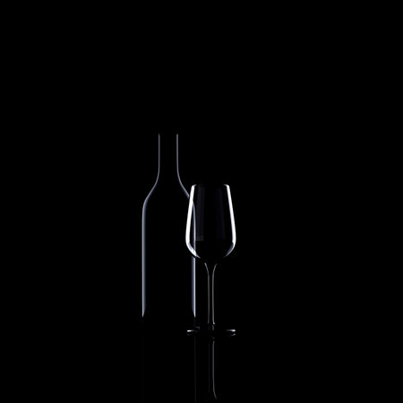Bottle and glass of red wine on black backgroundの写真素材