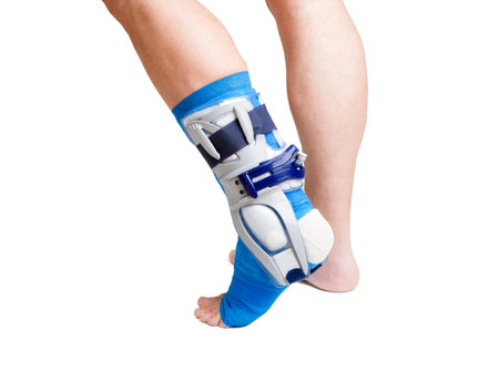 Man with a broken leg with  bandage on a white background の写真素材