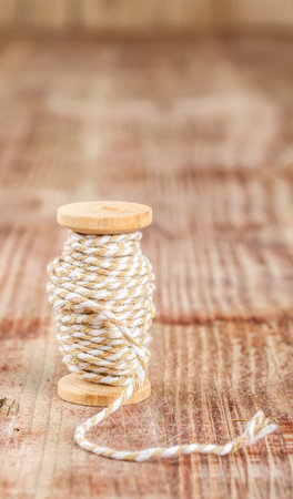 old vintage wooden spool of thread on wooden background