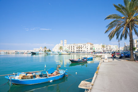 Molfetta, Apulia, Italy - JUNE 3, 2017 - Traditional fishing boats at the harbor promenade of...