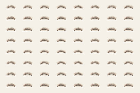 Pavers eyelashes on yellow background. Female cosmetics. Extension and lengthening of eyelashes. Pattern.の写真素材