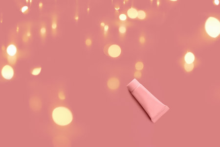 Blank tube layout on red background. Cosmetic product. Skin care. Female hygiene. Gift for holiday.の写真素材