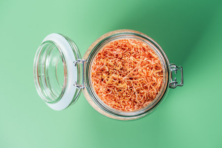 Dried carrots in glass jar for cooking. Vegetable drying in dehydrator. Healthy and healthy food.の写真素材