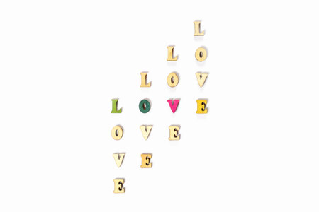 Inscription love made of wooden letters with hearts for Valentines Day. Festive hearts for declaration of love and strong relationship.の写真素材