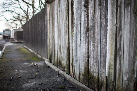 old wooden fence and the street selective focusの写真素材