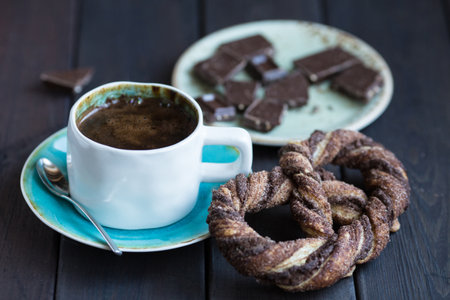 Cup of coffee with chocolate and pretzel