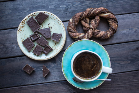 Cup of coffee with chocolate and pretzel. Top viewの写真素材