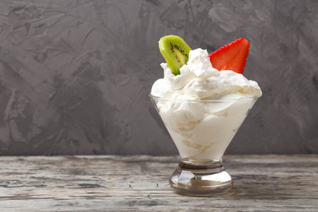 whipped cream in a cup with strawberries.の写真素材