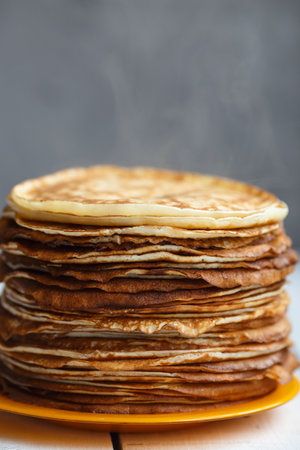 High stack of classic Russian thin pancakes. Rustic style. Traditional for the Russian pancake week Maslenitsaの写真素材