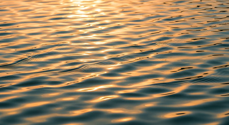 Water surface reflects sunlight. Calm serene texture with abstract pattern.の素材