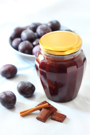 Plum jam with chocolate and cinnamon in a jar
