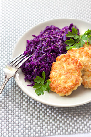 Chicken fritters and stewed red cabbage with caraway seedsの写真素材