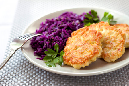 Chicken fritters and stewed red cabbage with caraway seedsの写真素材