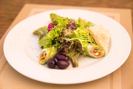 Spinach crepes with salmon and salad mixの写真素材