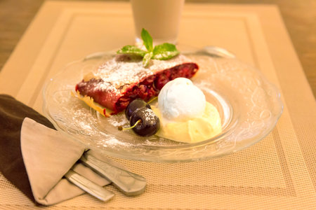 Cherry strudel with vanilla ice-cream and custardの写真素材