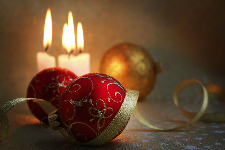 The burning candles, balls and gold ribbons it are Christmasの写真素材