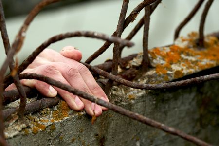 The hand of the man which wants freedom.の写真素材