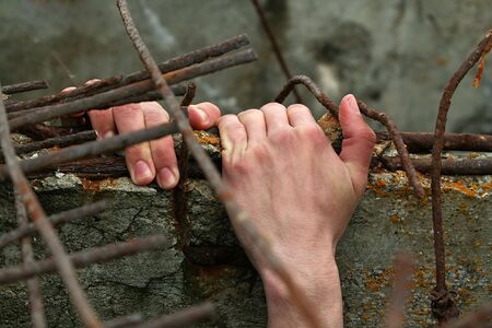 The hand of the man which wants freedom.の写真素材