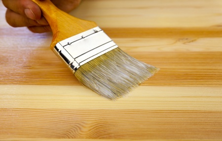 Wood texture, human hand and paintbrush / housework backgroundの写真素材