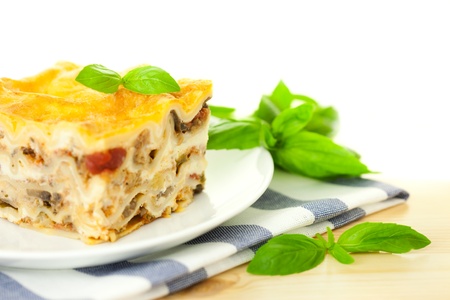 Delicious Italian Lasagna   with fresh basil   white background and copy spaseの写真素材