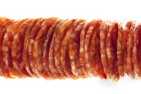 Salami / macro picture of few slices of salami isolated on white backgroundの写真素材