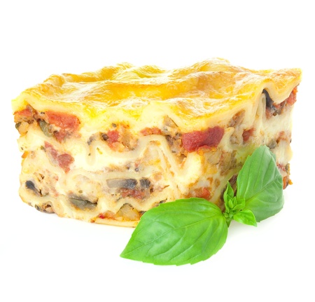 Home-baked hot Lasagne with fresh Basil / Isolated on white / Focus is all overの写真素材