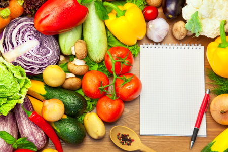 Fresh Vegetables Composition on the Wooden Background and Notebook for Recipes or Menuの写真素材