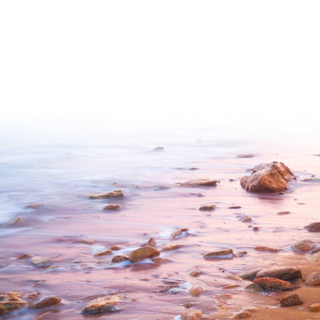 Smooth Sea and Stones on Sunrise - with white area for textの写真素材