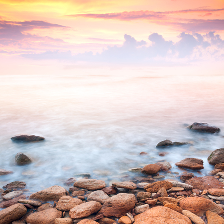 beautiful sunrise over the rocky sea coast, wonderful worldの写真素材