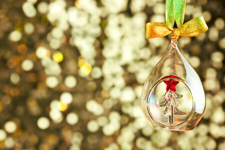 Christmas magic light background with glass bauble and colorful ribbon - copy space for textの写真素材