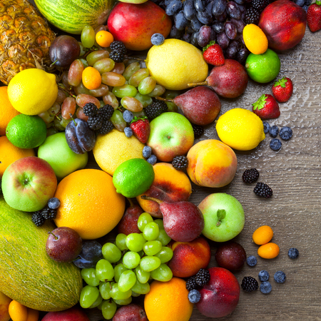 Mix of Fresh Organic Fruits  with water drops on wooden table background - Healthy Eatingの写真素材