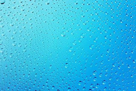 Blue Abstract Water Drops  Background with Beautiful Light and Shadows -  focus on the center, horizontalの写真素材