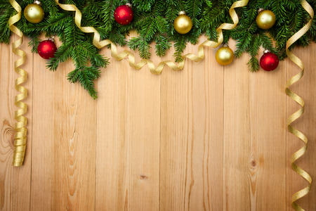 Christmas background with fresh firtree, baubles and ribbons on wood - horizontalの写真素材