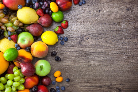 Colorful Fruits on wooden Table with water drops  の写真素材