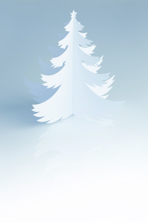 Handmade paper Christmas Tree silhouette on blue white background の写真素材