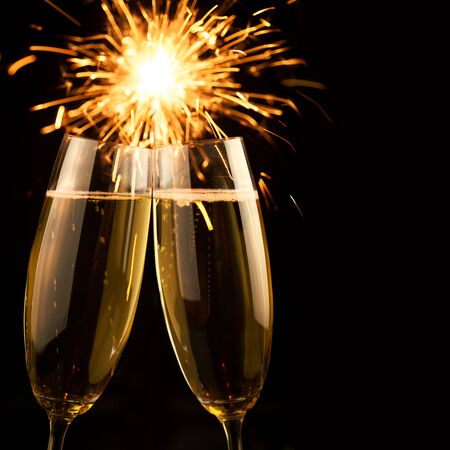 Beautiful golden champagne with sparklers on black background - squareの写真素材