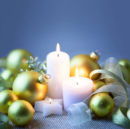 Blue Night Christmas background with candles, baubles and ribbons - copy spaceの写真素材