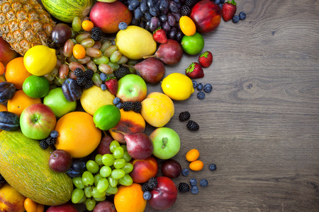 Mix of Fresh Fruits  on dark wooden table with copy spaceの写真素材