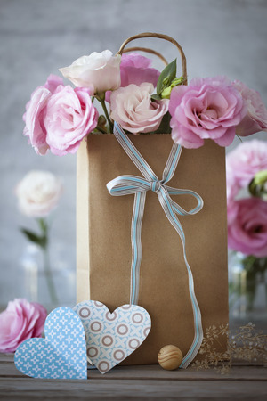 St. Valentines Day background with pink flowers, blue bow and heartsの写真素材