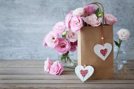 Romantic Retro style Love background with pink roses and handcrafted heartsの写真素材