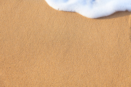 Soft wave of the sea on the sandy beach - summertimeの写真素材