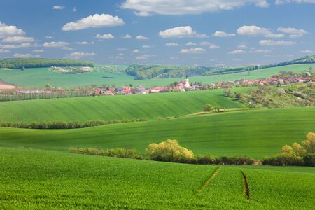 Panorama of  Little town on the green hills, blue sky, smalll houses and nature,  summer vacation concept, Europe, Czech Republicの写真素材