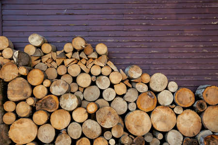 Background of wood logs and old wall, with copy space for textの写真素材