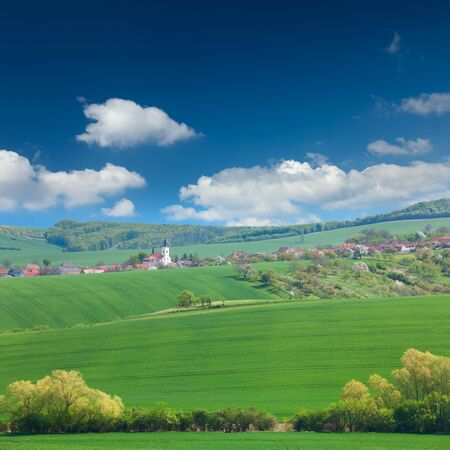 Little town on the green hills, blue sky, beautiful buildings and nature, traditional architecture, summer vacation concept, Europe, Czech Republicの写真素材
