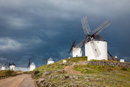 Old Spanish windmills on dramatic sky and rainy weather, Campo de Criptana, Castilla la Mancha province, Spain, Europeの写真素材