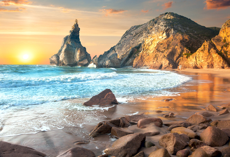Sea Landscape at Sundown time, beautiful rocks and stones beach. Portugal, Europeの写真素材