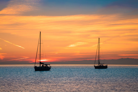 Yachts in the sea at sunset time, Yachting tourism - maritime evening walk. Romantic trip on luxury...