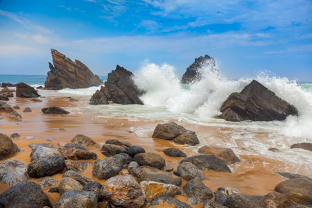 Ocean beach landscape - Big waves breaking on the shore with rocks, Portugal, European travelの写真素材
