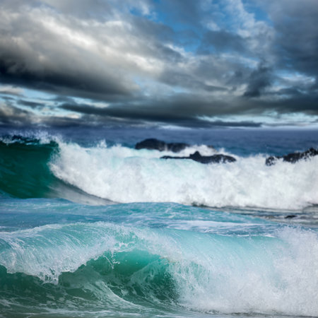 Dangerous stormy weather - dramatic dark clouds and big ocean waves, focus in the frontの写真素材
